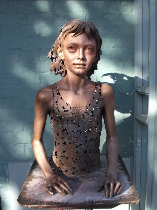 Portrait of a young girl - her hair and dress are leaves